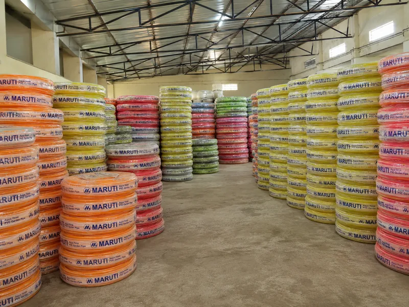 Rows of Maruti Aqua Hose PVC garden pipe coils stacked in the finished goods store