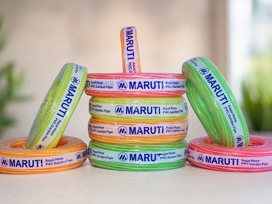 Coils of Maruti Aqua Hose PVC garden pipe in green, orange, blue and pink
